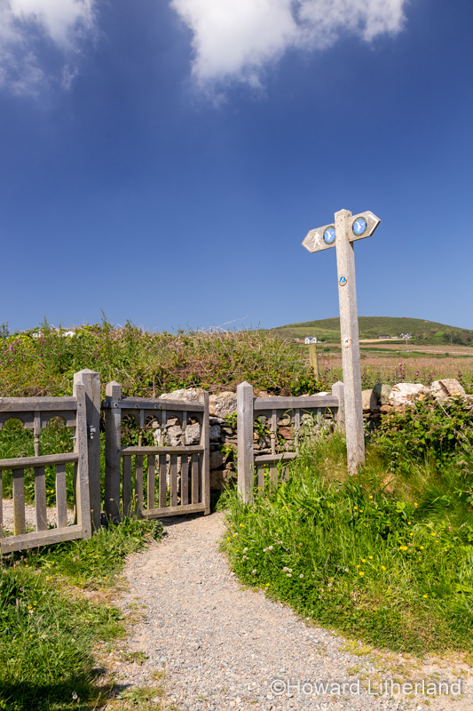 Gate and signpost on the Anglesey Coastal Path at Church Bay, Anglesey, North Wales