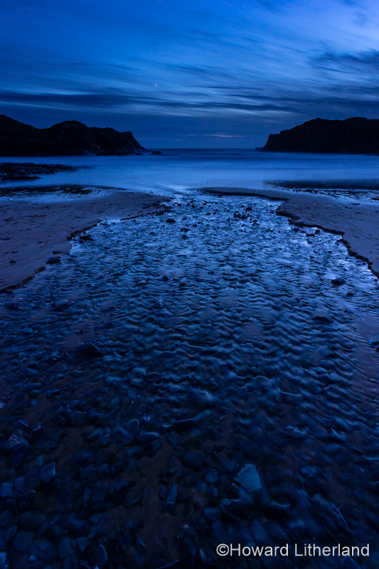Dusk over the beach at Porth Dafarch on the Anglesey coast, North Wales