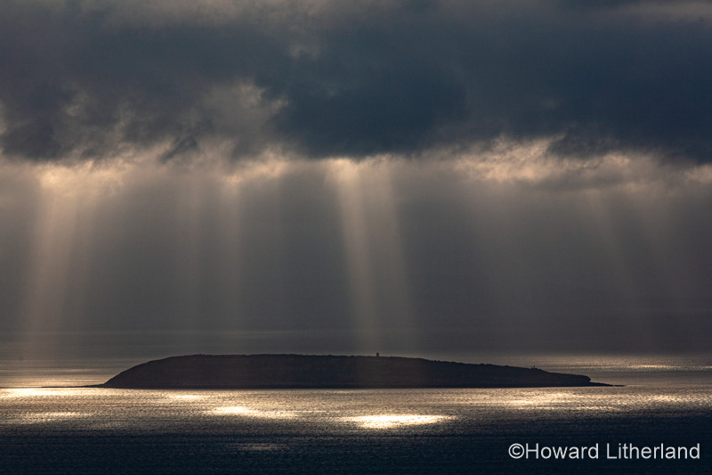 Puffin Island, Anglesey, North Wales with clouds and sunbeams