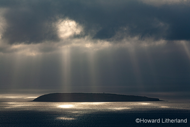 Puffin Island, Anglesey, North Wales with clouds and sunbeams