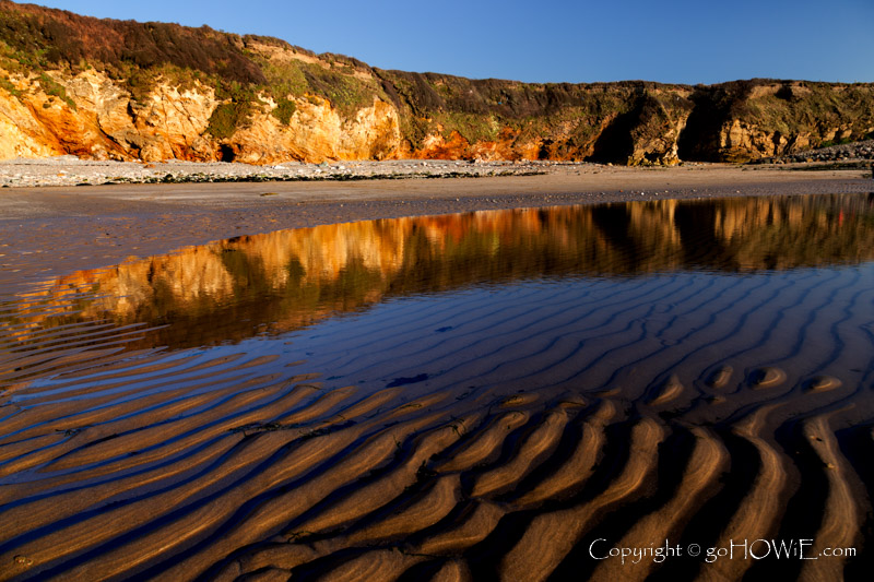 Beach, tidal pool and cliffs at Church Bay, Anglesey