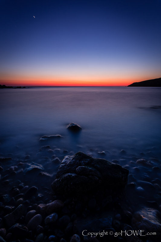 The beach at Church Bay, Anglesey, at twilight with rocks and sea