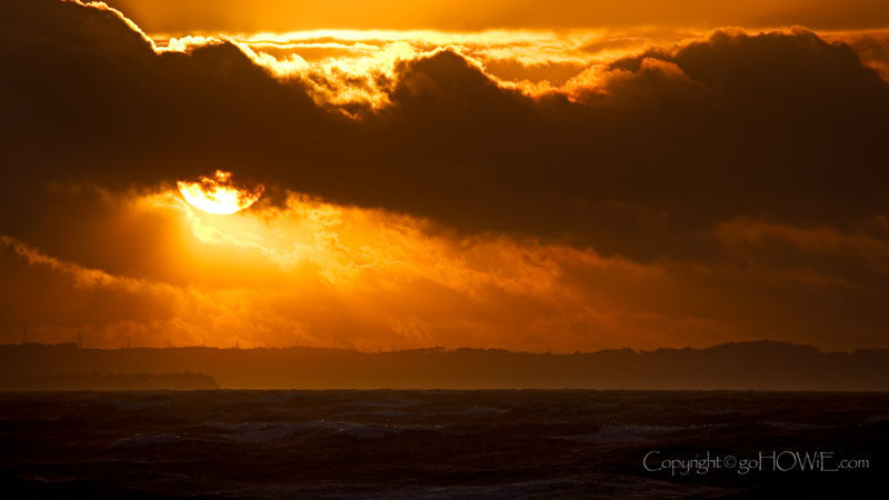 The sun setting though stormy clouds over the Irish Sea, taken from the West Shore, Llandudno on the North Wales coast