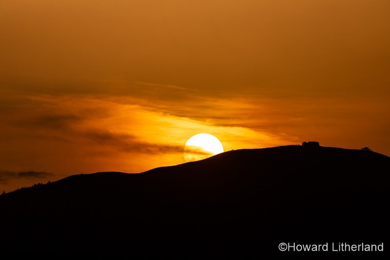 Sunset over the Jubilee Tower on the summit of Moel Famau, North Wales