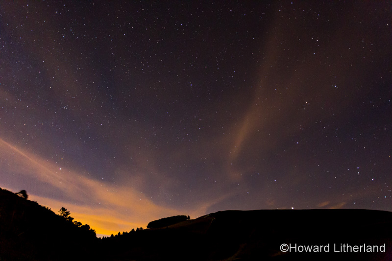 Stars and clouds over the Clwydian Range at night, North Wales
