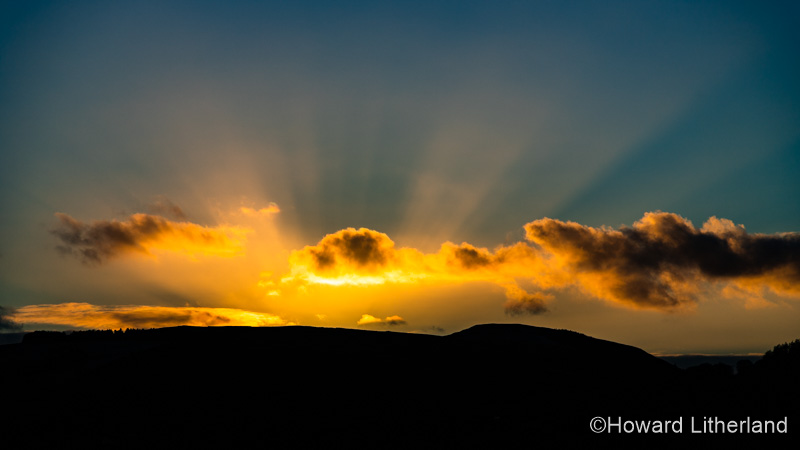 Sunbeams at sunset over the Clwydian Range, north Wales