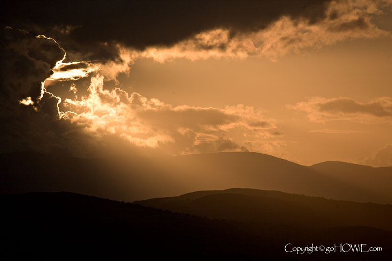 The sun shining through clouds over the Clwydian Range, North Wales