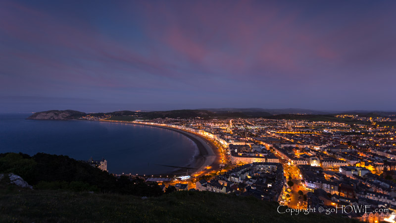 Llandudno Bay and the Little Orme at dusk with street lights, North Wales coast