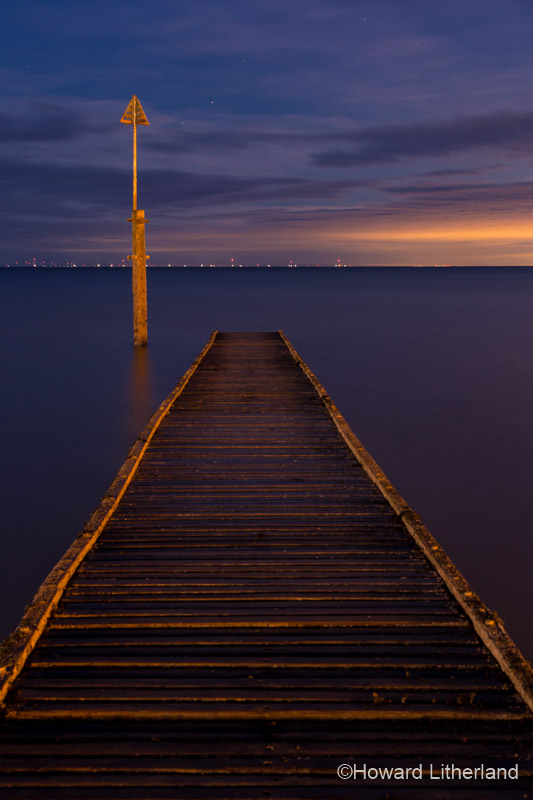 Wooden jetty in the sea at Llandudno at night on the North Wales coast