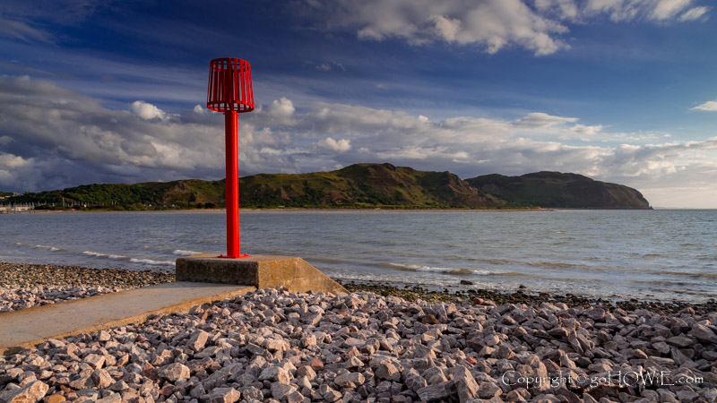 Red marker post at the West Shore at Llandudno, North Wales coast