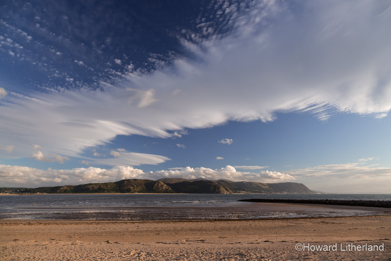 Wave cloud at sunset over the West Shore at Llandudno on the North Wales coast