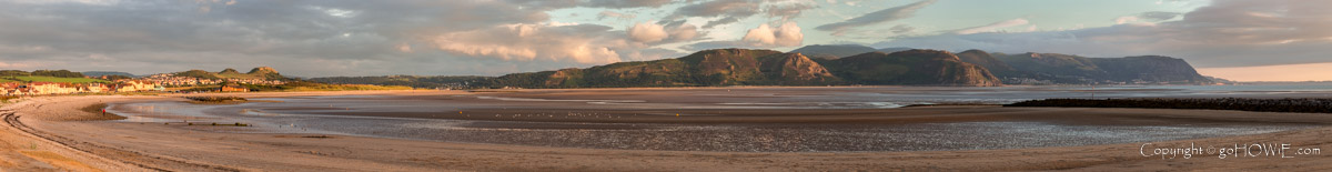 Panoramic image of the beach at Llandudno West Shore, looking out over the Conwy estuary to the headland at Penmaenmawr on the North Wales coast