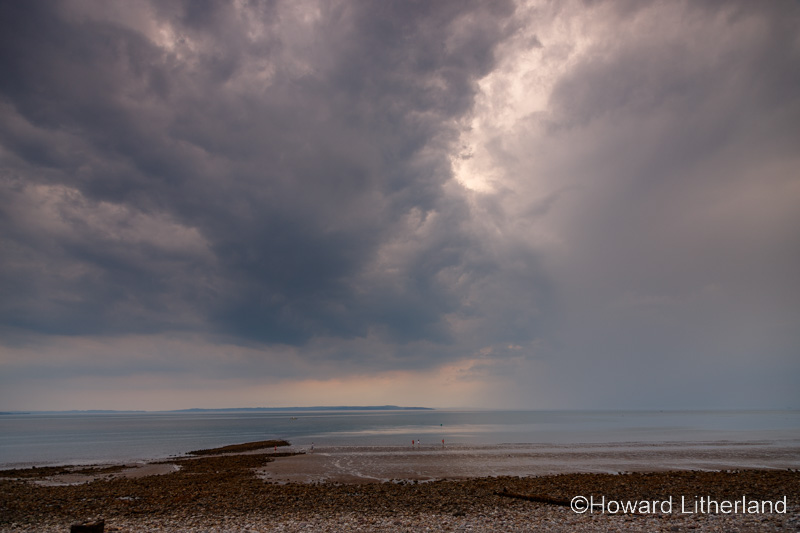 Storm clouds and rain over the West Shore at Llandudno on the North Wales coast
