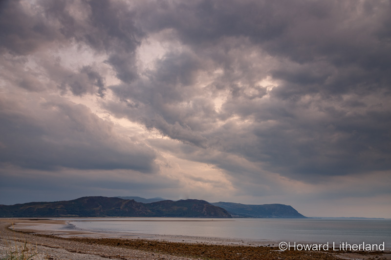 Storm clouds and rain over the West Shore at Llandudno on the North Wales coast