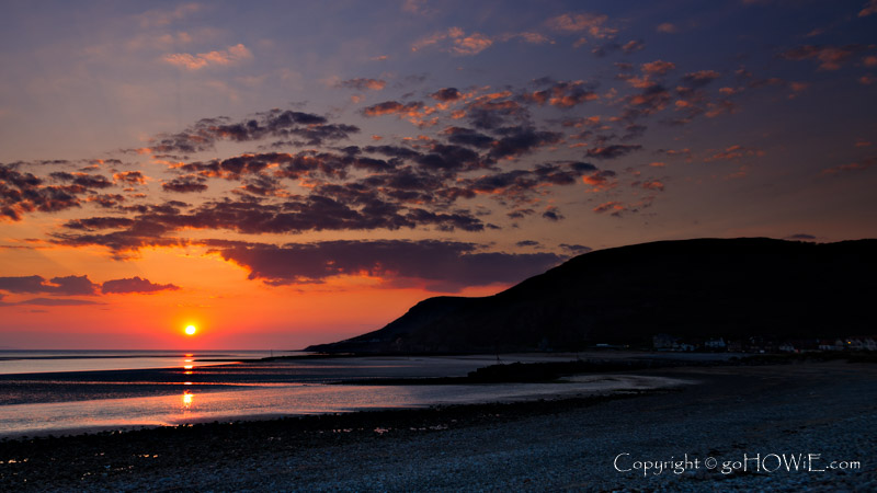 Sunbeams at sunset over the sea at Llandudno, North Wales