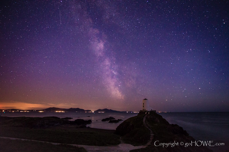 The milky way arching over the watchtower at the tip of Llanddwyn Island, Anglesey, North Wales