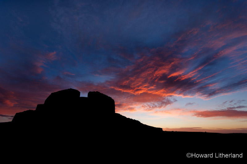 Clouds lit by dawn light over the Jubilee Tower at the summit of Moel Famau, North Wales