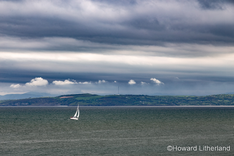 Yacht under sail at Moelfre, Anglesey, North Wales