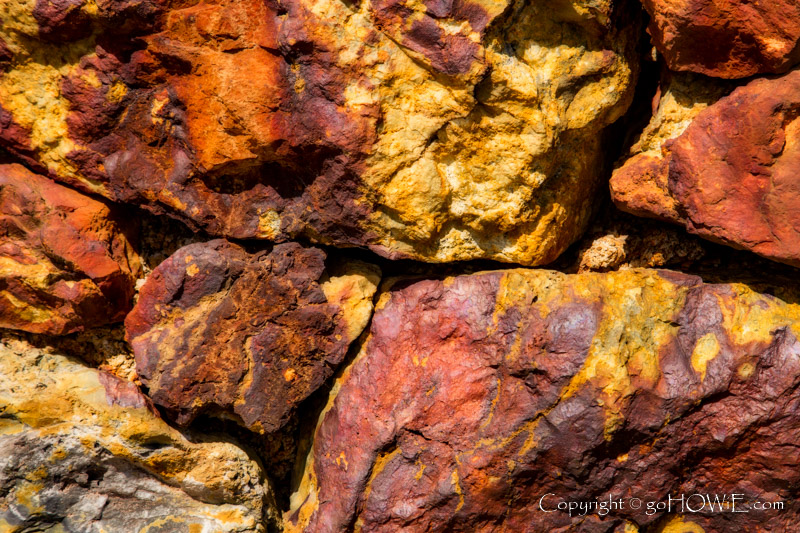 Coloured rocks at Parys Mountain copper mine, Anglesey, North Wales