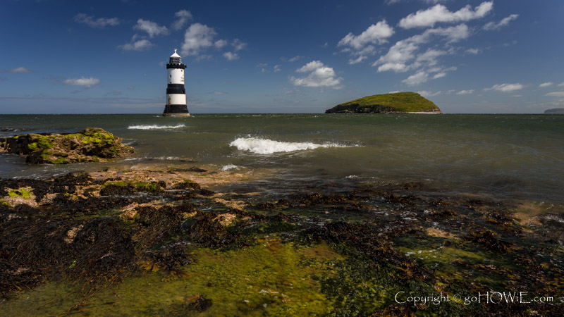 Penmon Point lighthouse and Puffin Island on an incoming tide, Anglesey, North Wales