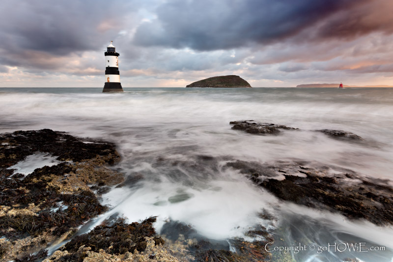 Penmon lighthouse and Puffin Island under stormy clouds, Anglesey, North Wales