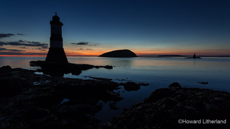 The lighthouse at Penmon Point and Puffin Island at dawn on a low tide, Anglesey, North Wales coast