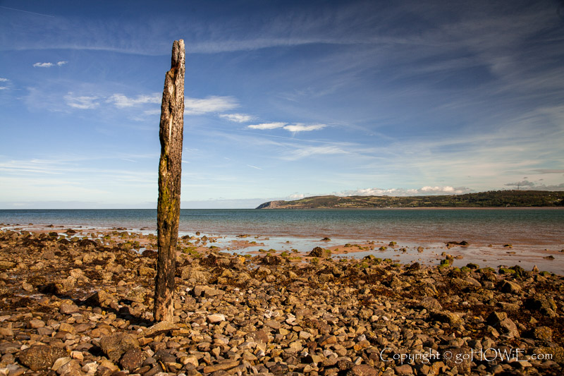 Decaying mooring post on the beach at Red Wharf Bay, Anglesey, North Wales