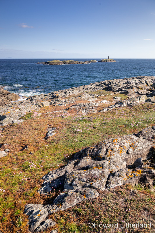 Rocky coastline and island at Rhoscolyn, Anglesey, North Wales on a sunny day