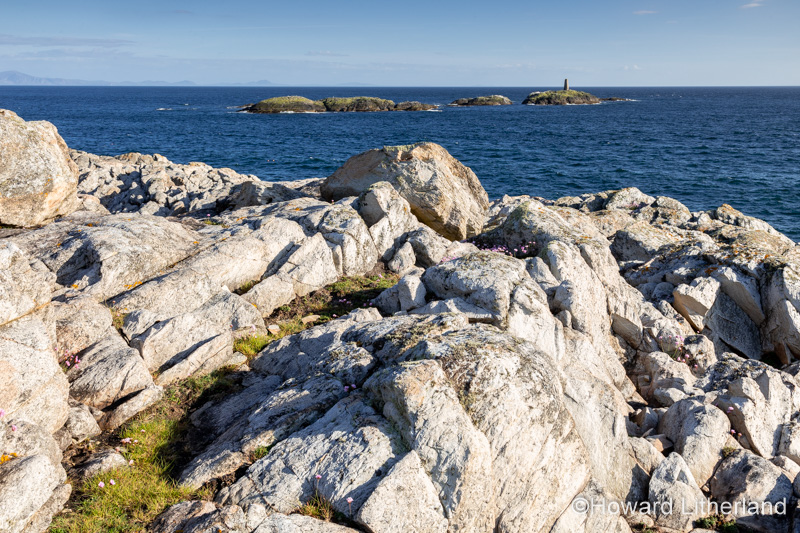 Rocky coastline and island at Rhoscolyn, Anglesey, North Wales on a sunny day