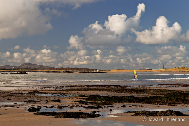 Wind surfer on the beach at Rhosneigr on Anglesey, North Wales