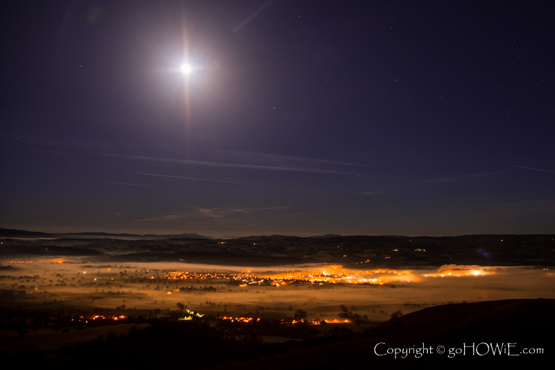 Moon setting over mist shrouded Ruthin in the Vale of Clwyd, North Wales