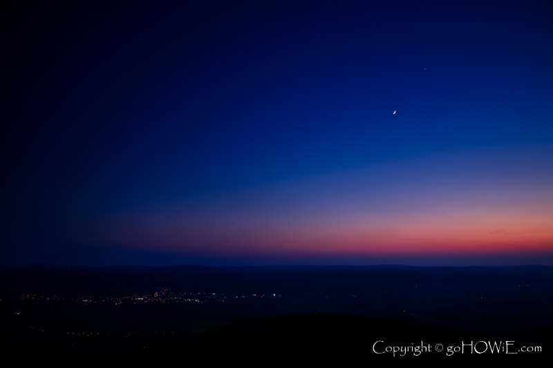 A waxing crescent moon in conjunction with the planet Venus over Ruthin in the Vale of Clwyd, North Wales