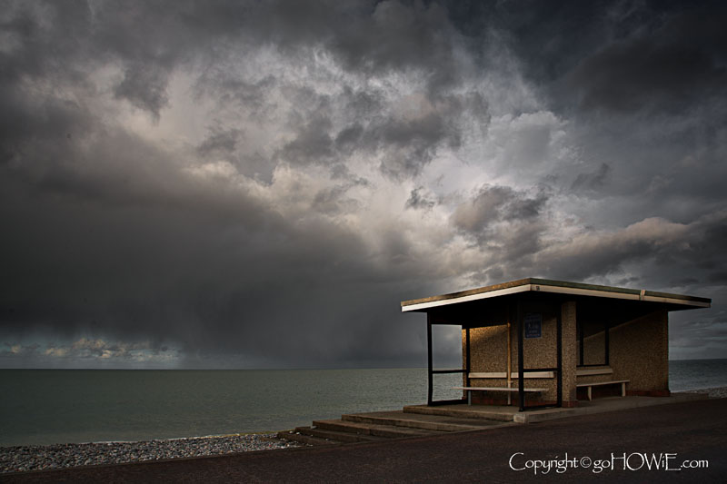 Llandudno East Shore promenade shelter with storm clouds, North Wales coast