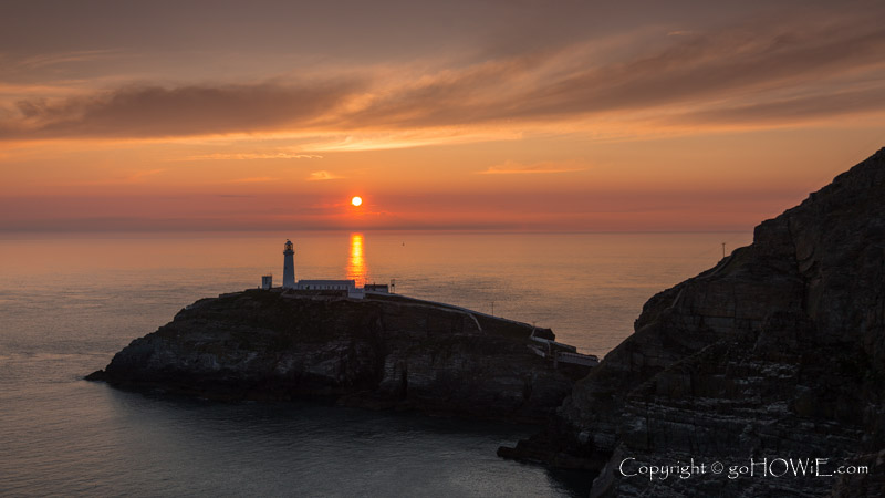 Sunset with colourful clouds over the South Stack lighthouse on the Isle of Anglesey, North Wales