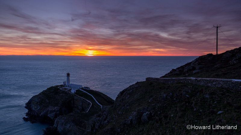Colourful sunset over the South Stack Lighthouse on the Isle of Anglesey, North Wales
