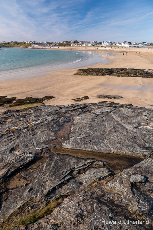 Rocks and the sandy beach at Trearddur Bay, Anglesey, North Wales