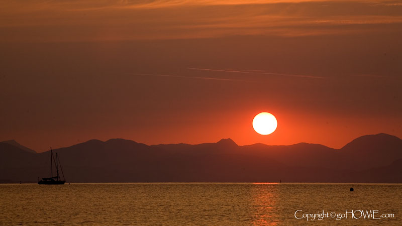 Sun rising over Snowdonia, viewed from the beach at Abersoch on the Llyn Peninsula