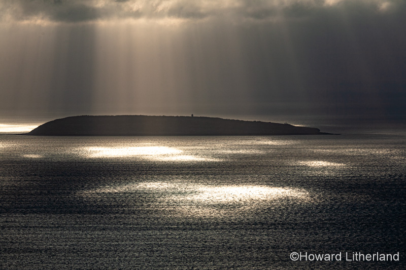 Puffin Island, Anglesey, North Wales with clouds and sunbeams
