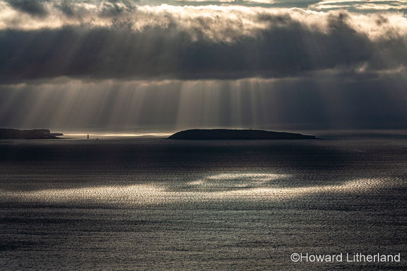 Puffin Island, Anglesey, North Wales with clouds and sunbeams