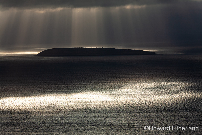 Puffin Island, Anglesey, North Wales with clouds and sunbeams