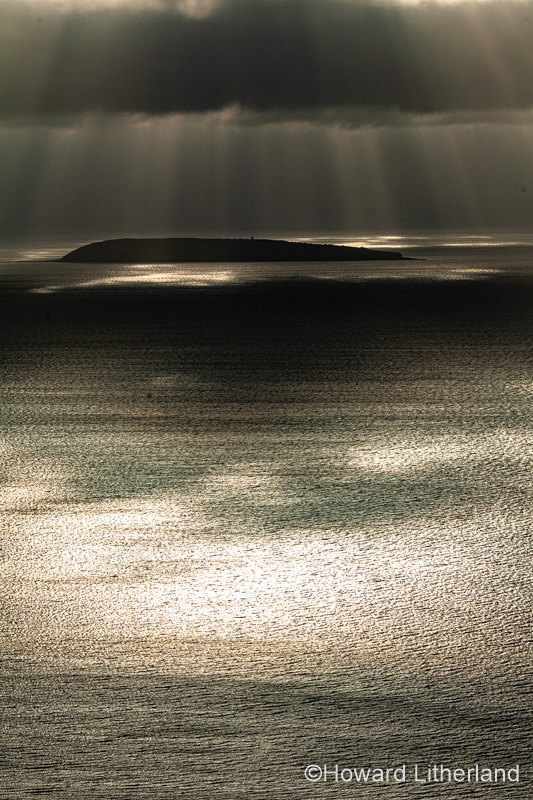 Puffin Island, Anglesey, North Wales with clouds and sunbeams