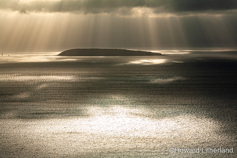 Puffin Island, Anglesey, North Wales with clouds and sunbeams