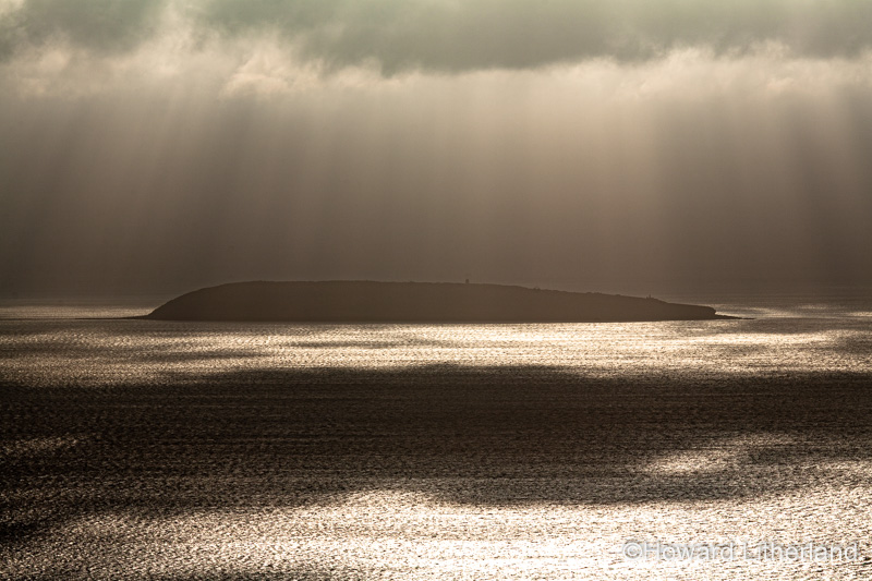 Puffin Island, Anglesey, North Wales with clouds and sunbeams