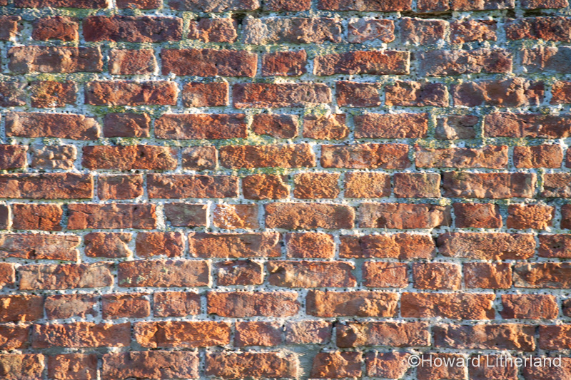 Old, weathered bricks in wall