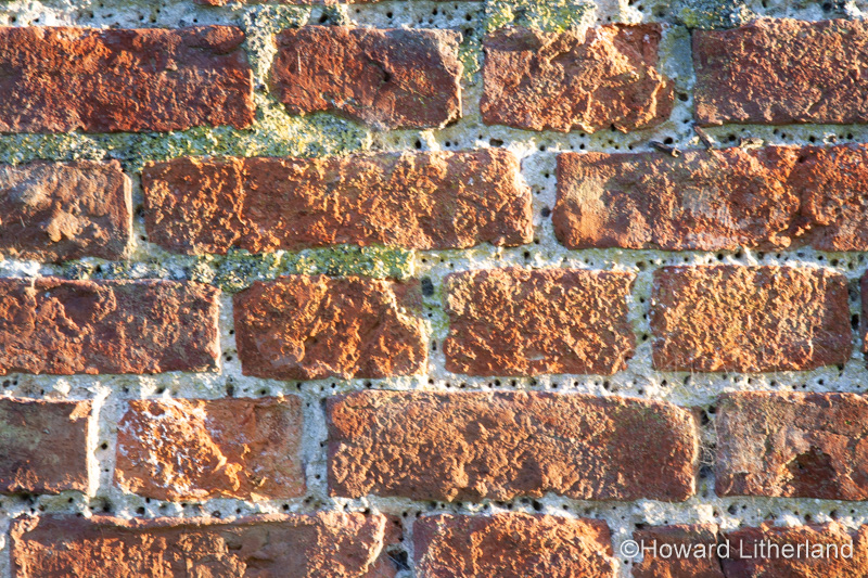 Old, weathered bricks in wall