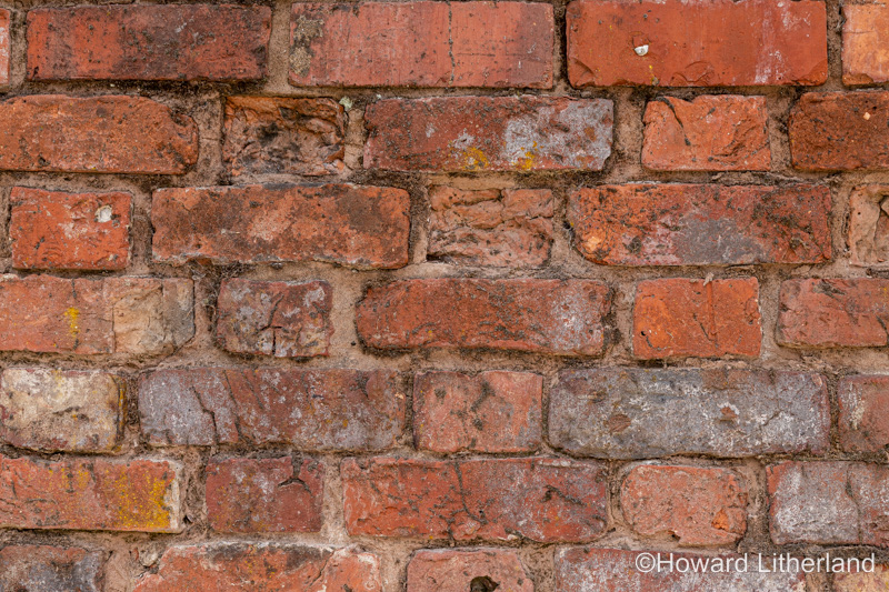 Wall made of old discoloured bricks