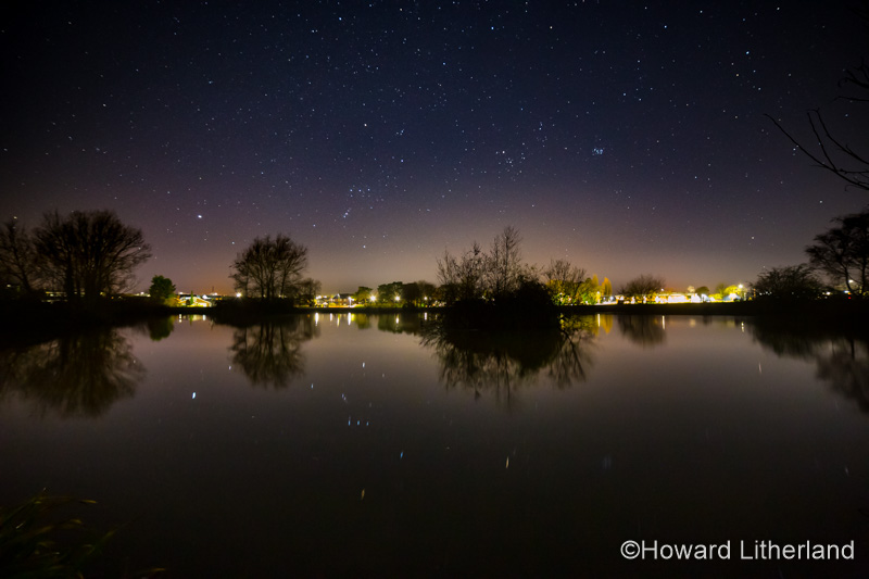 Stars and satellites reflecting in a lake, Buckley, North Wales