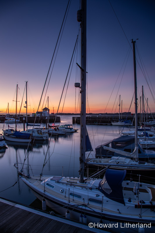 Boats moored in Victoria Dock, Caernarfon, North Wales at dusk