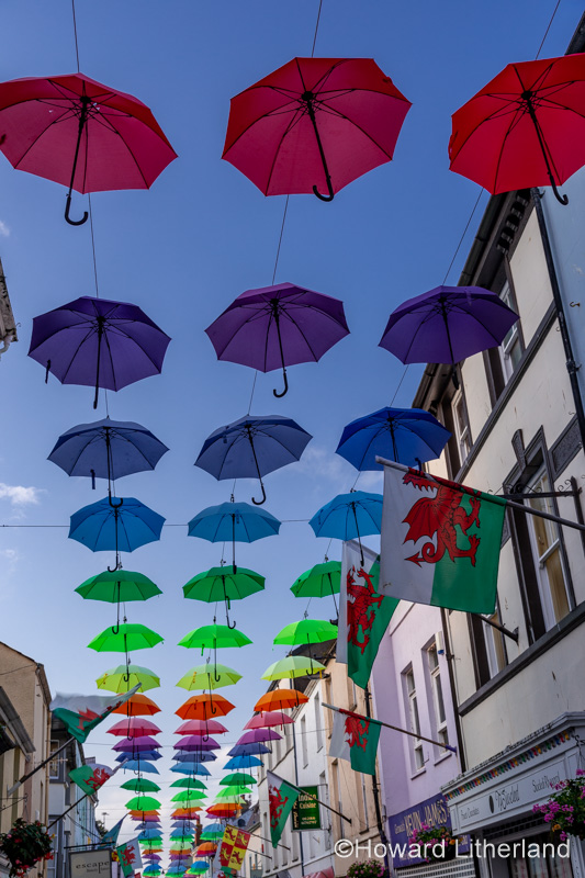 Multi-coloured umbrellas over Palace Street, Caernarfon, North Wales