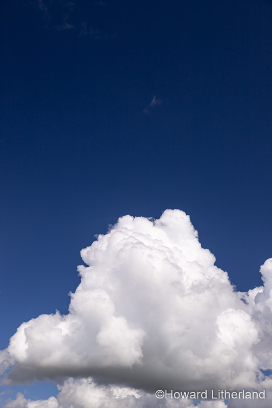 Large cumulus cloud in a deep blue sky